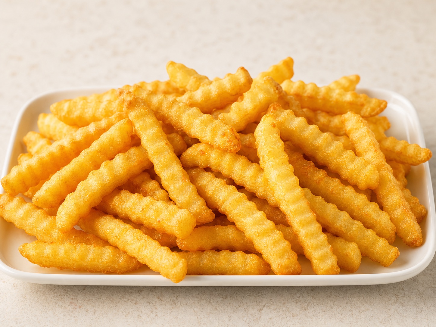 Golden frozen crinkle cut fries with wavy ridges
